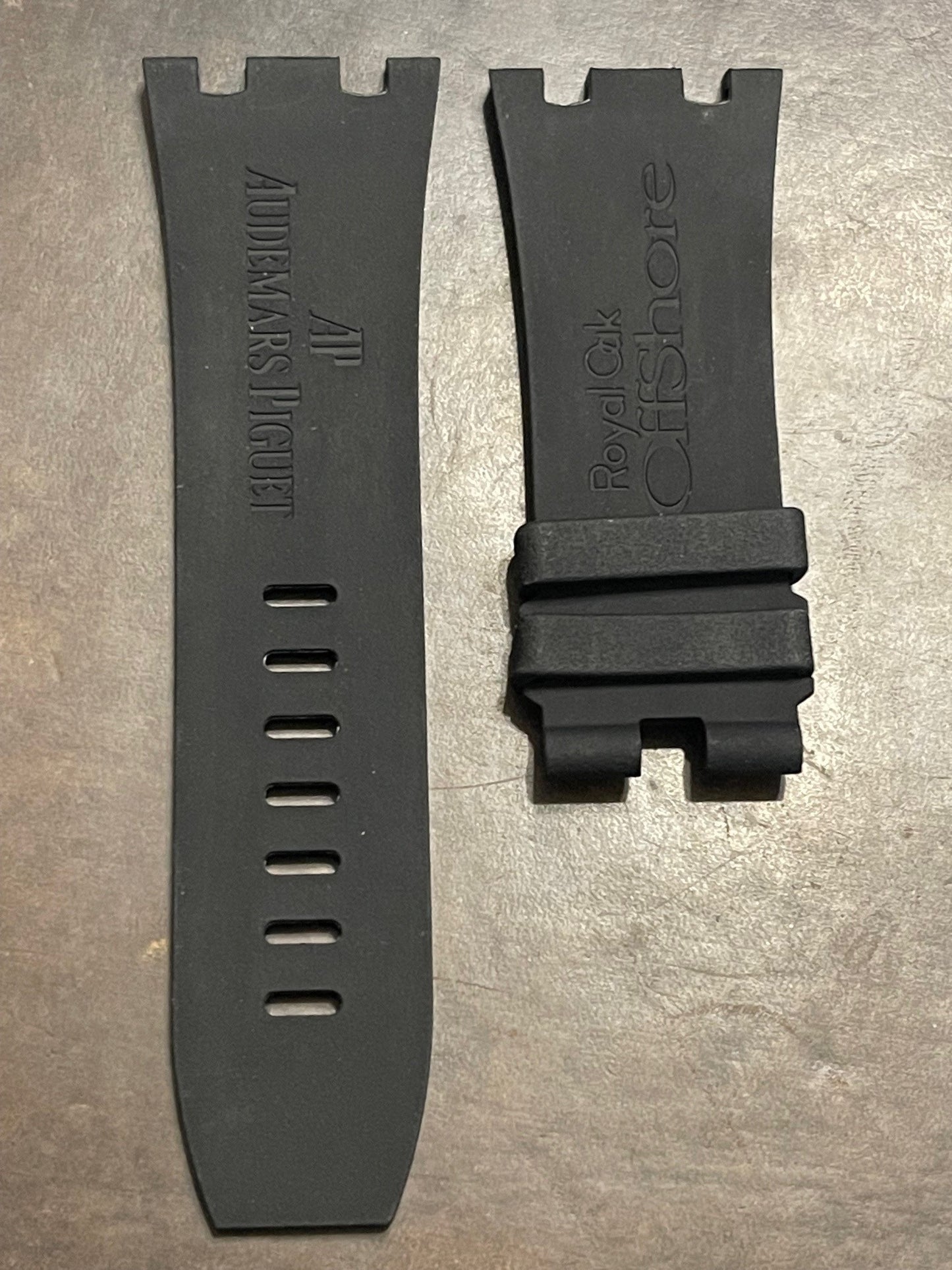 Black AP rubber watch straps with Audemars Piguet and Royal Oak Offshore embossing on textured background
