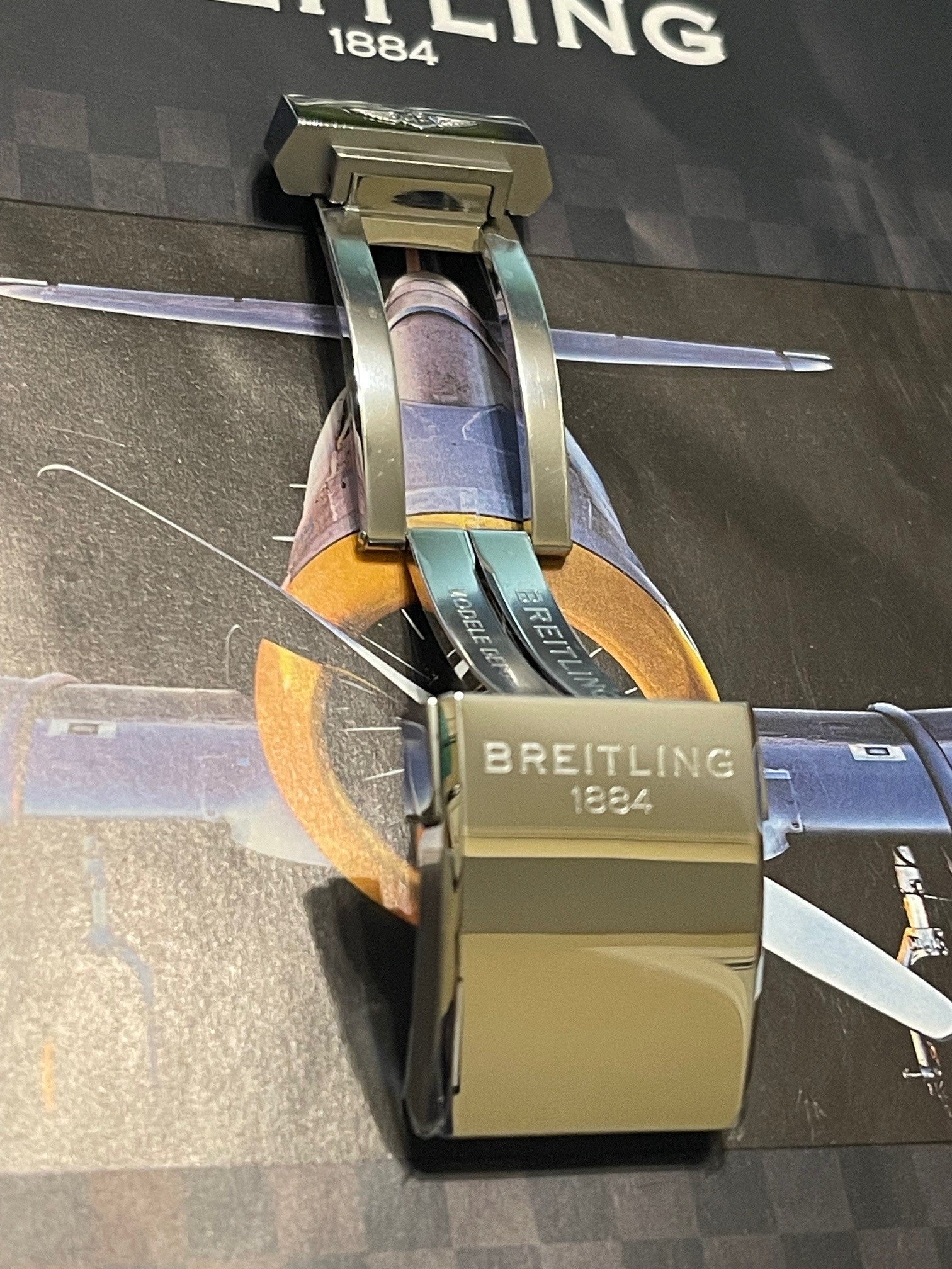 Breitling watch strap clasp featuring brand name and established year on display background