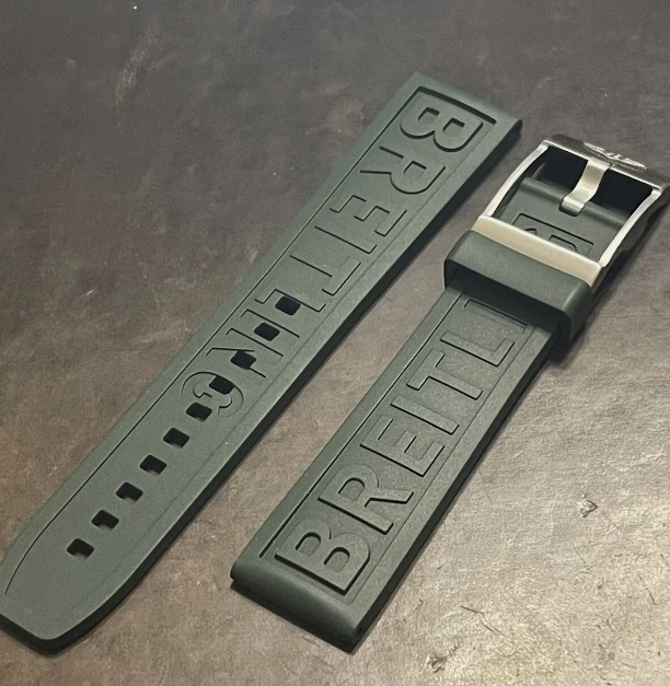 Breitling rubber watch strap in green featuring embossed branding and metal buckle