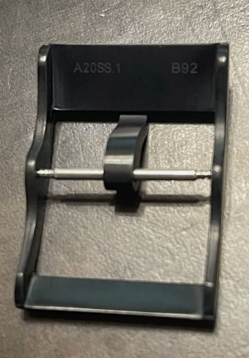 Black metal clip with A20SS.1 and B92 engravings shown against dark backdrop