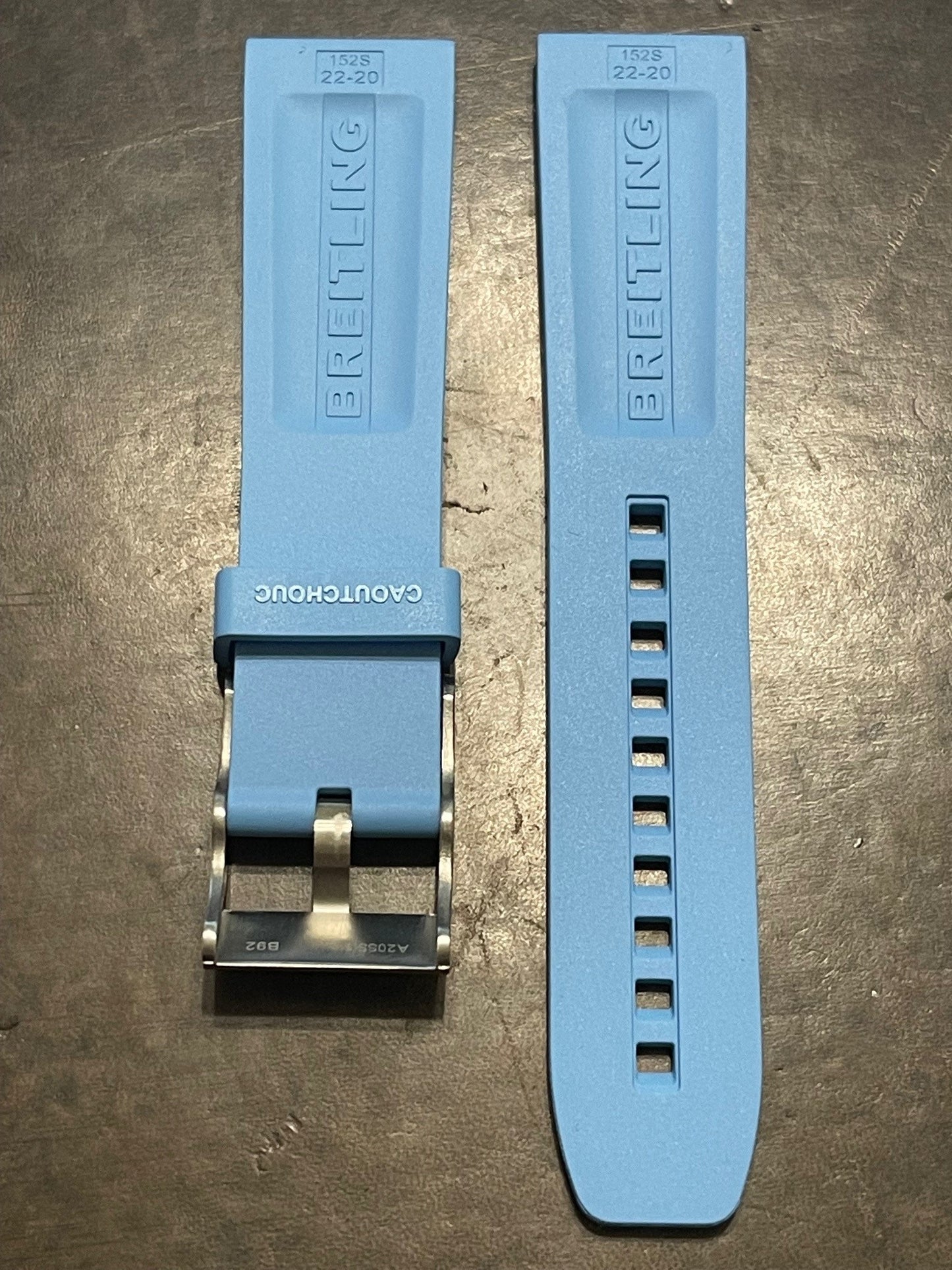 Breitling rubber watch strap in light blue featuring logo, buckle, and fit adjustment holes