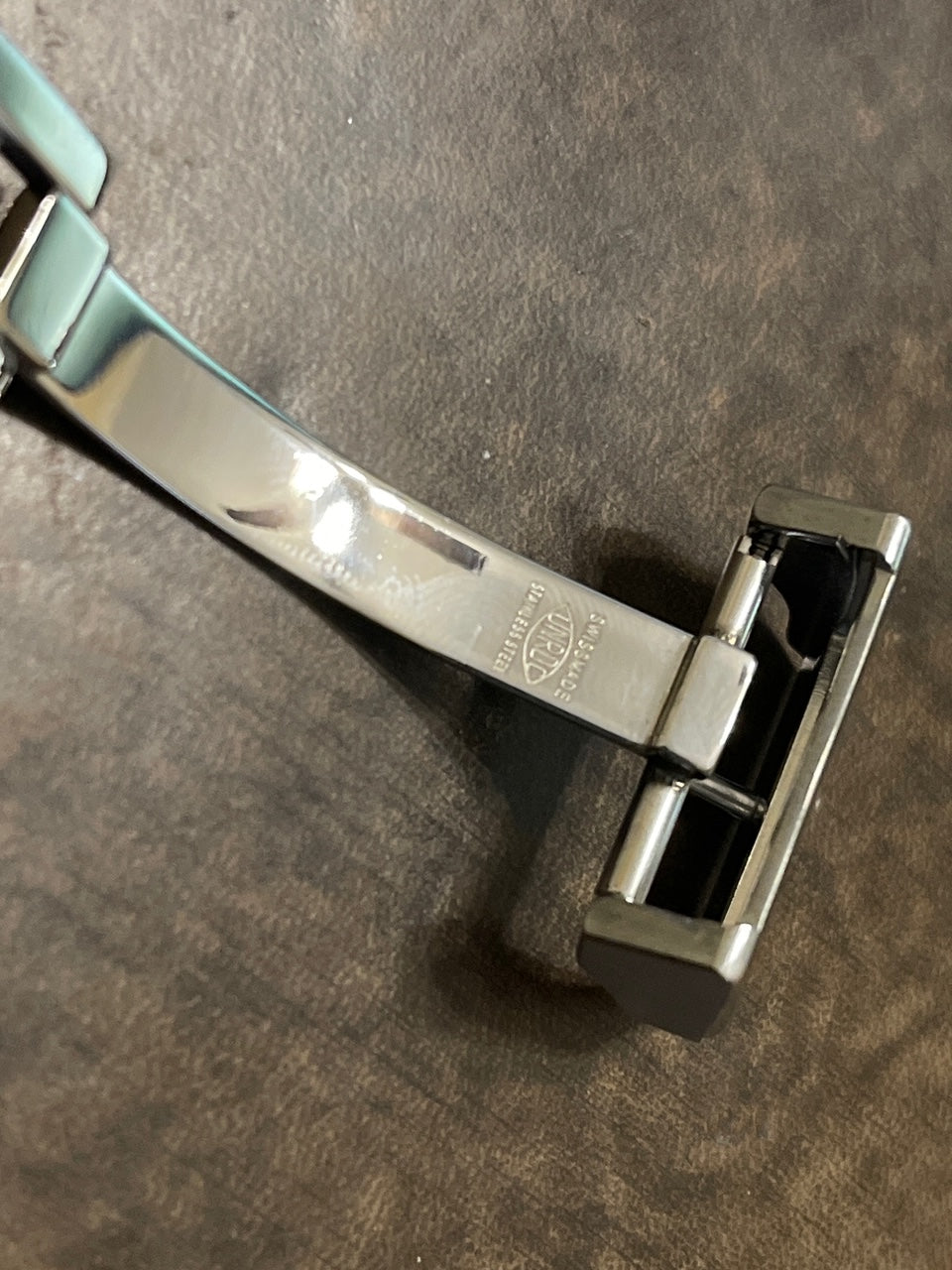 Panerai Brown Alligator leather watch straps, long and short with metal studs on dark surface"