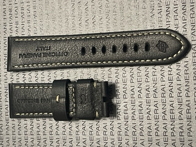 Black leather watch strap with Officine Panerai branding, off-white stitching, and shiny clasp
