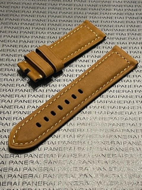 Tan leather Panerai strap with white stitching and loop piece on branded background