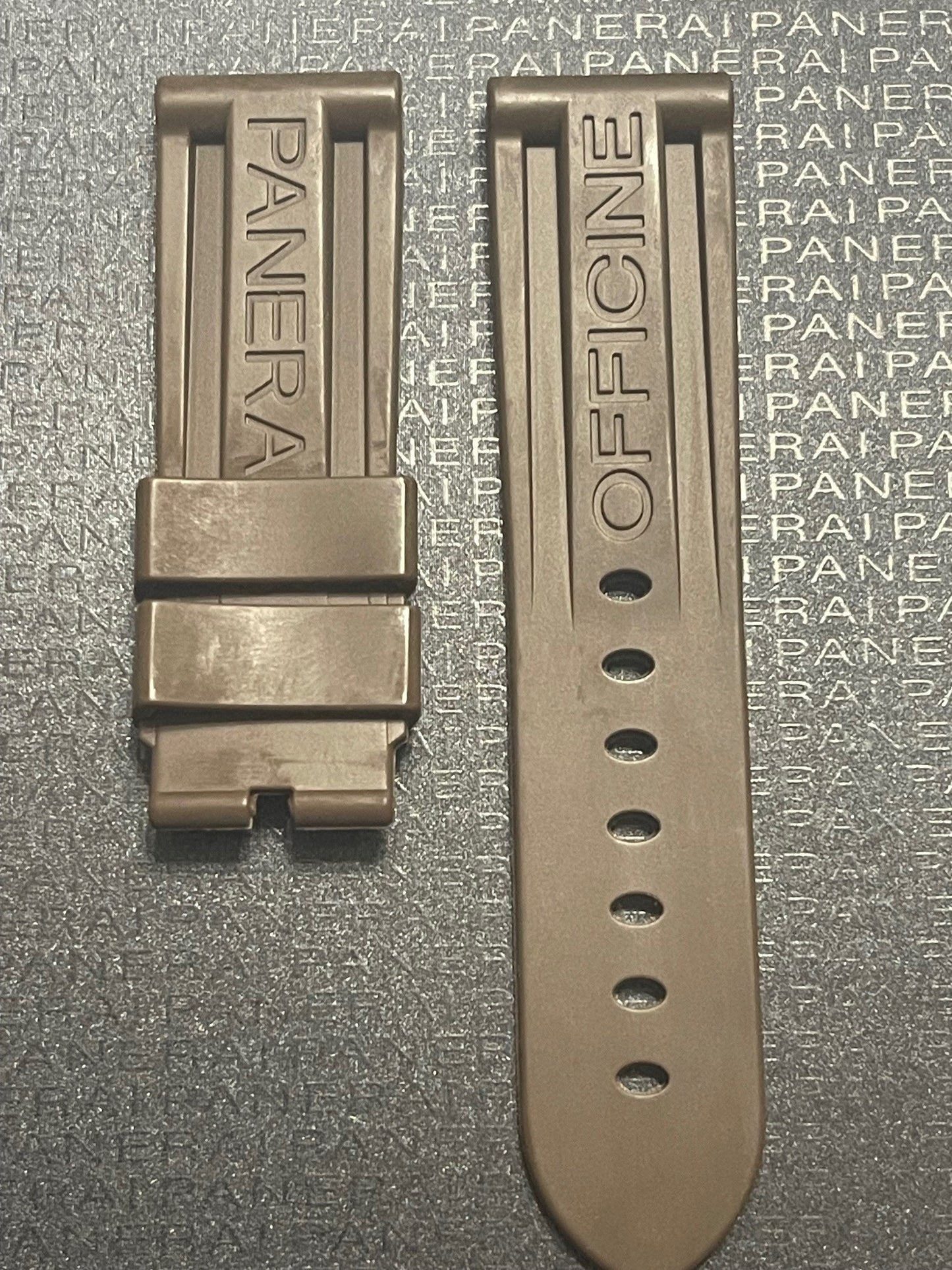 Panerai watch strap in bronze with buckle, set against black background with PANERAI branding