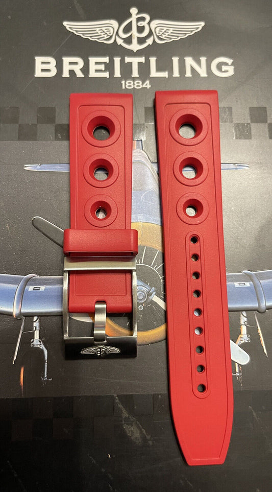 Breitling rubber watch strap in bright red with silver buckle on vintage aircraft background