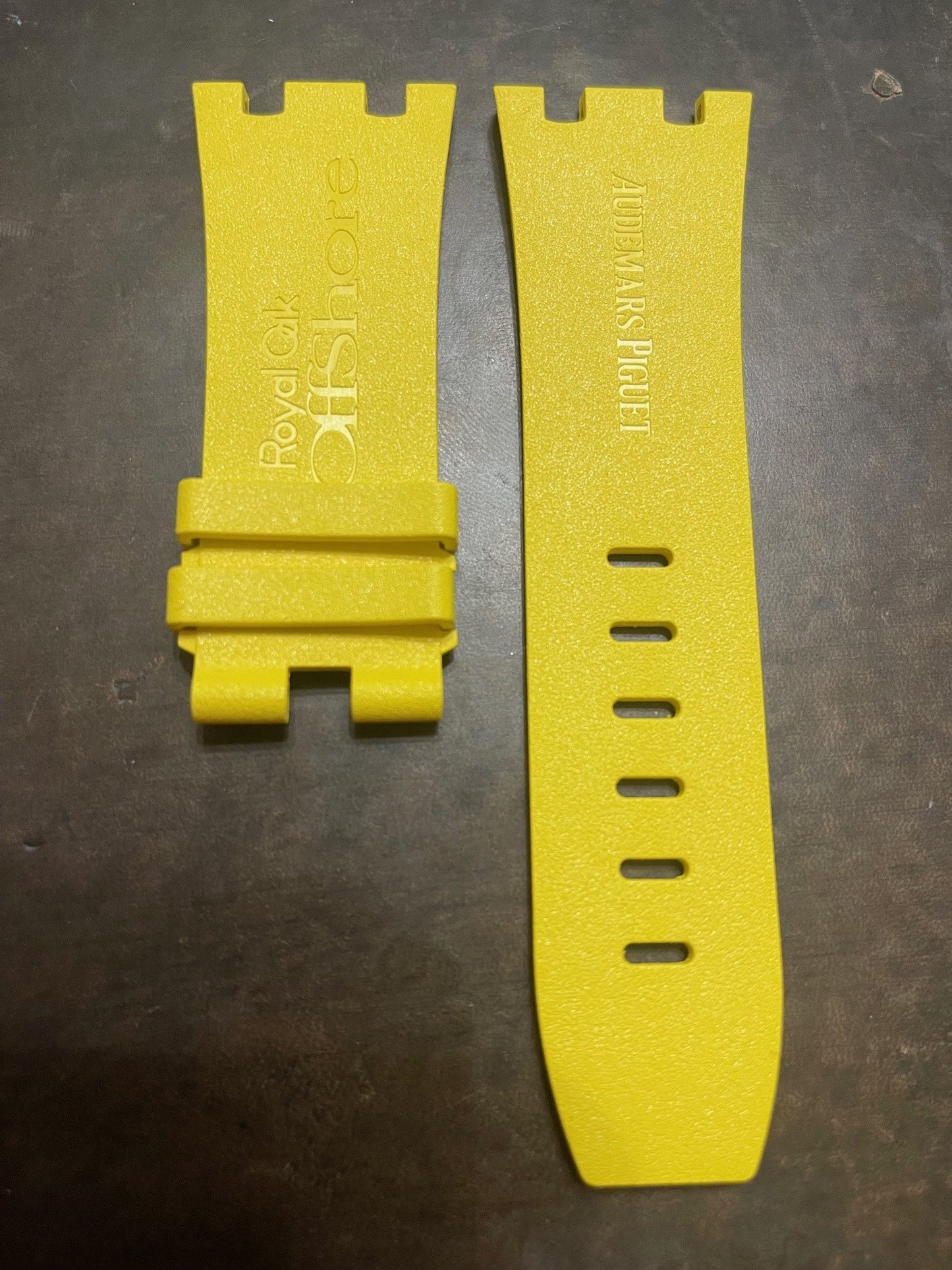 Two yellow rubber watch bands side by side labeled Royal Oak Offshore and Audemars Piguet