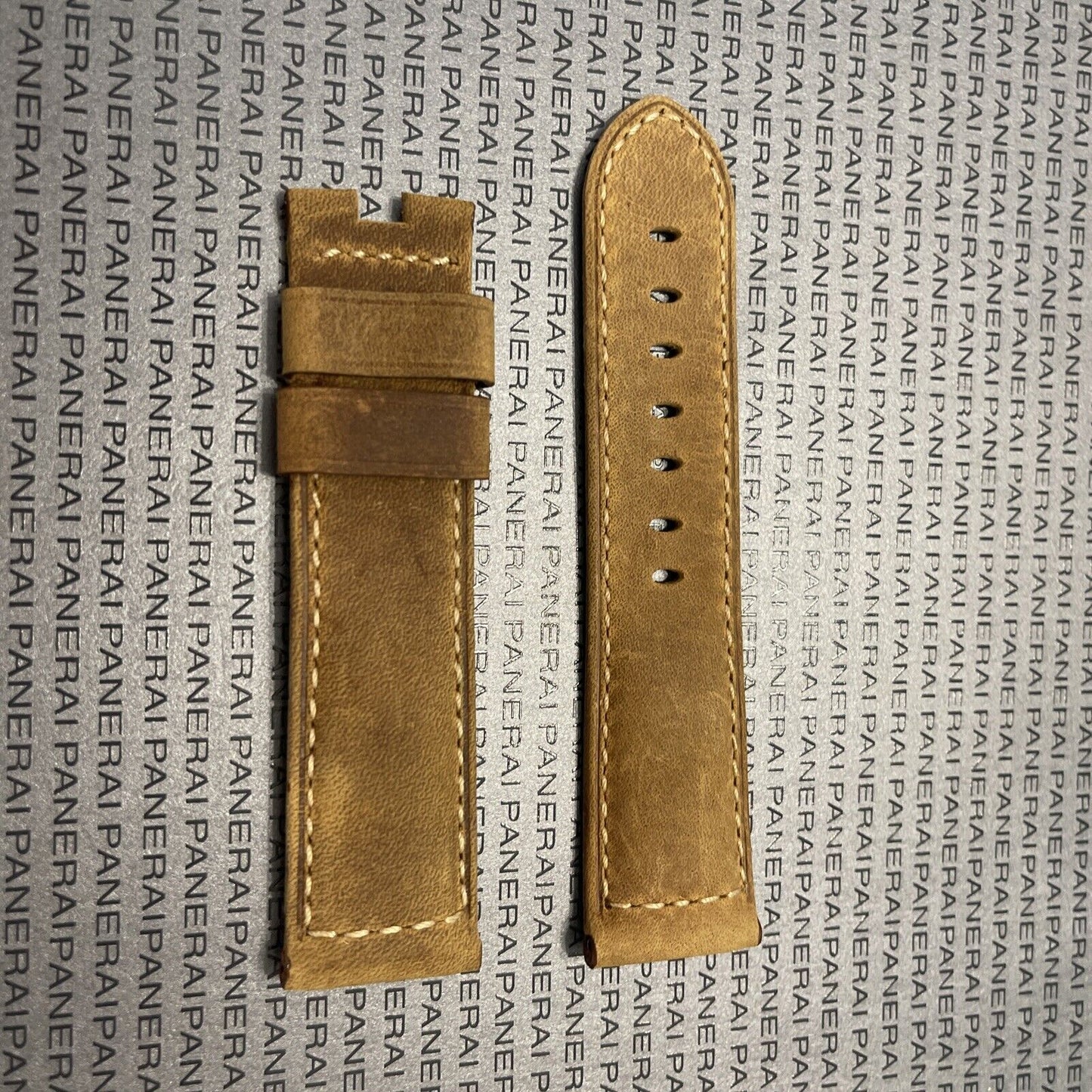 Panerai watch strap in tan leather with detailed stitching on branded surface