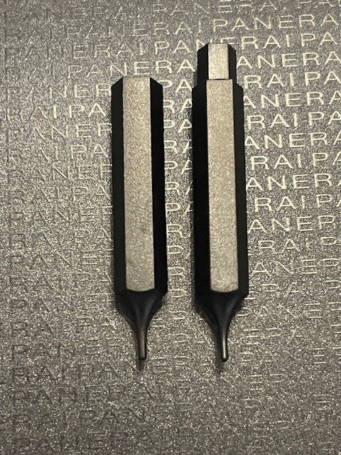 Panerai watch tools with distinct tips placed on embossed PANERAI logo background
