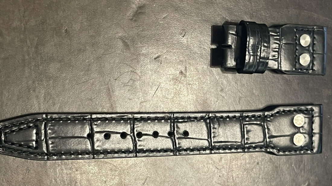 Black watch strap with two holes and a buckle, designed for premium quality IWC Big Pilot accessories.