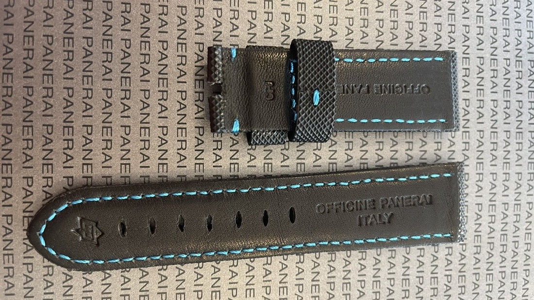 Black leather watch strap featuring blue stitching, highlighting a classic design amidst bold rubber trends for Fall 2025.