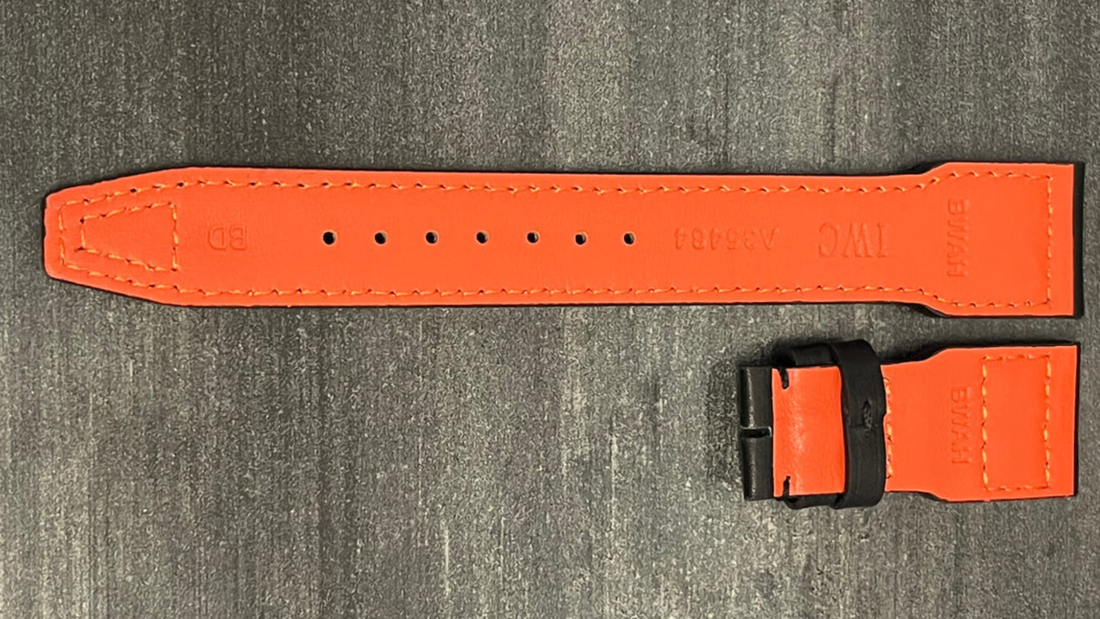 An orange watch strap featuring a black buckle, showcasing a stylish accessory option for your timepiece.
