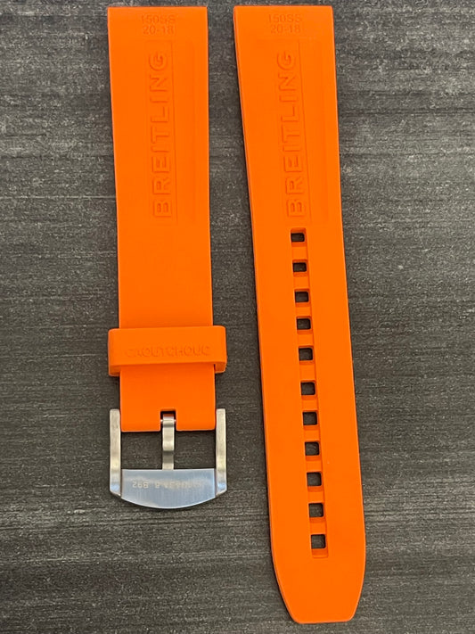An orange watch strap with a polished silver buckle, emphasizing a bold and fashionable accessory choice.