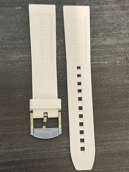 A white watch strap featuring a sleek black buckle, showcasing a modern and stylish design.